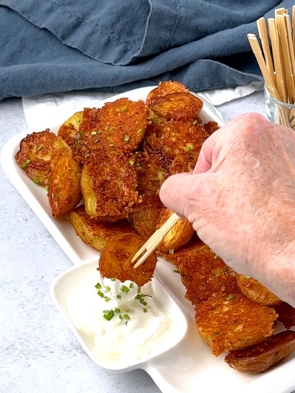 Crispy Parmesan Roasted Potatoes are tasty dipped in sour cream, ranch or ketchup.