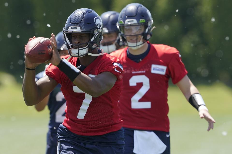 FILE - Seattle Seahawks quarterbacks Drew Lock (2) and Geno Smith (7) take part in a drill during NFL football practice, Tuesday, May 31, 2022, in Renton, Wash. Geno Smith and Drew Lock are the candidates to be the starting QB. (AP Photo/Ted S. Warren, File)