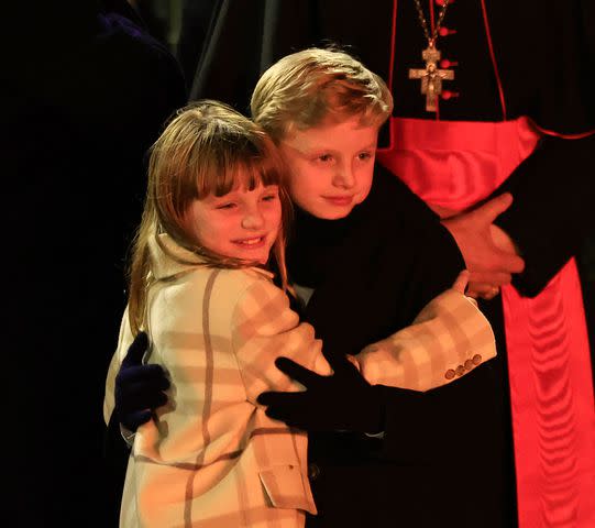 <p> VALERY HACHE/AFP via Getty </p> Princess Gabriella and Prince Jacques share a hug at the traditional celebration of Sainte Devote in Monaco on January 26.