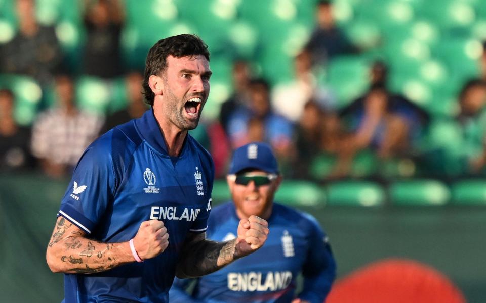 England's Reece Topley celebrates after taking the wicket of Bangladesh's Mushfiqur Rahim during the 2023 ICC Men's Cricket World Cup one-day international