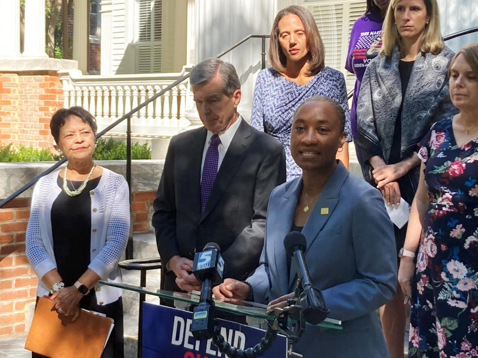 FILE - EMILY's List President Laphonza Butler, right, speaks while North Carolina Gov. Roy Cooper, left, and others listen at a news conference outside state Democratic Party headquarters in Raleigh, N.C., Tuesday, Sept. 27, 2022. California Gov. Gavin Newsom has named Butler to fill the U.S. Senate seat made vacant by Sen. Dianne Feinstein's death. (AP Photo/Gary D. Robertson, File)