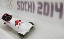 Canada's pilot Lyndon Rush (front) and his teammates speed down the track during a four-man bobsleigh training session at the Sanki Sliding Center in Rosa Khutor, during the Sochi 2014 Winter Olympics February 19, 2014. REUTERS/Arnd Wiegmann (RUSSIA - Tags: SPORT BOBSLEIGH OLYMPICS)