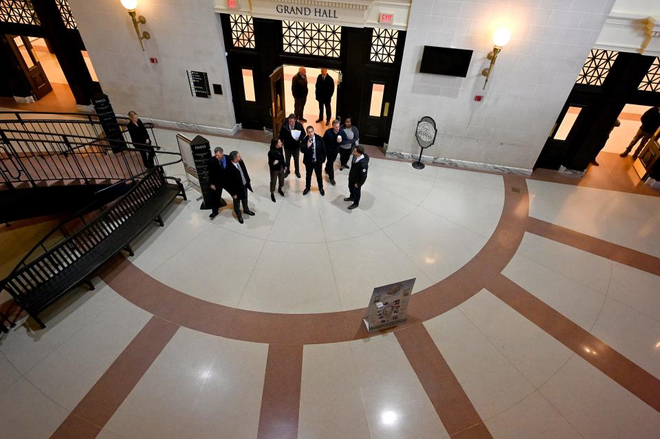 Project manager Anthony DeDominicis, center, takes MBTA, city and state officials on a tour of Union Station.