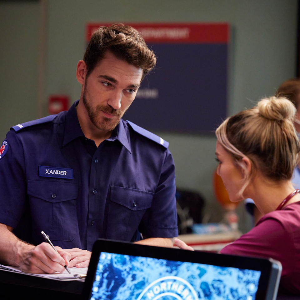 Xander in paramedic uniform talks to Jasmine at the hospital on Home and Away.