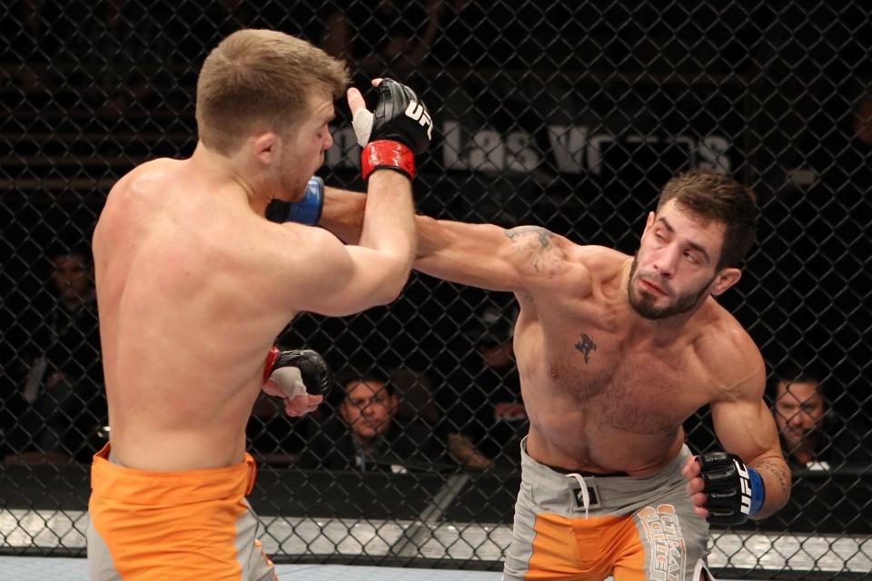 Dustin Neace hits Bryan Caraway (right to left) with a punch during The Ultimate Fighter 14 Finale at the Pearl Theatre at the Palms Hotel and Casino on December 3, 2011 in Las Vegas, Nevada. (Photo by Josh Hedges/Zuffa LLC/Zuffa LLC via Getty Images)