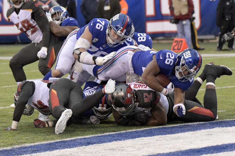 New York Giants' Saquon Barkley, top right, scores a touchdown during the second half of the team's NFL football game against the Tampa Bay Buccaneers on Sunday, Nov. 18, 2018, in East Rutherford, N.J. (AP Photo/Bill Kostroun)