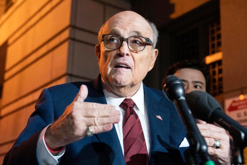 Former New York Mayor Rudy Giuliani talks to reporters as he leaves the federal courthouse in Washington on Dec. 11, 2023. The trial will determine how much Giuliani will have to pay two Georgia election workers who he falsely accused of fraud while pushing President Donald Trump's baseless claims after he lost the 2020 election.