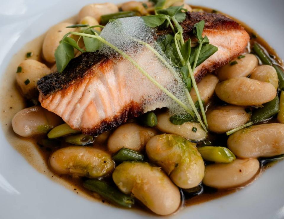 Pan-roasted salmon with winter bean cassoulet, Meyer lemon espuma and chervil oil at Napa.