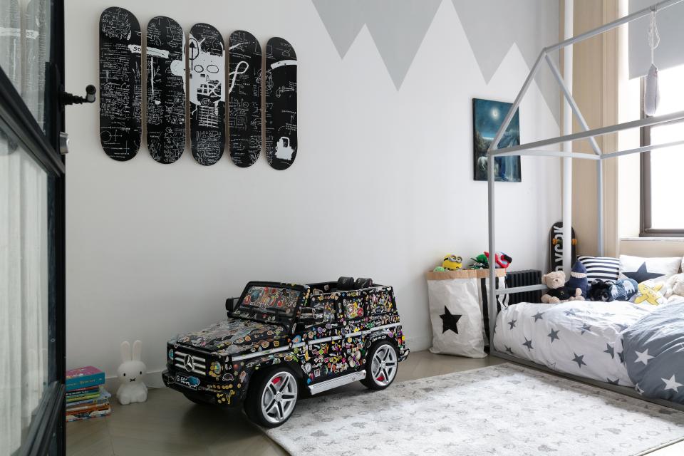 Skateboards by Jean-Michel Basquiat and Paolo Pelosini’s White Horse lend sophistication to the son's bedroom.