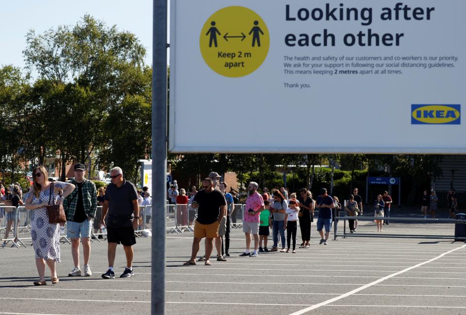 Shoppers in Warrington observe social distancing (Reuters)