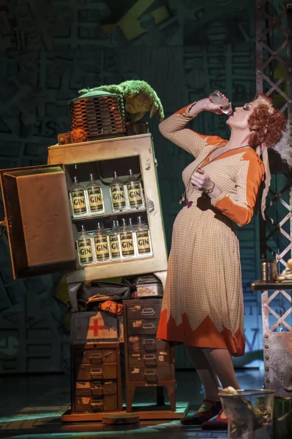 Photo of Miss Hannigan, a character in Annie The Musical, on stage, drinking gin.