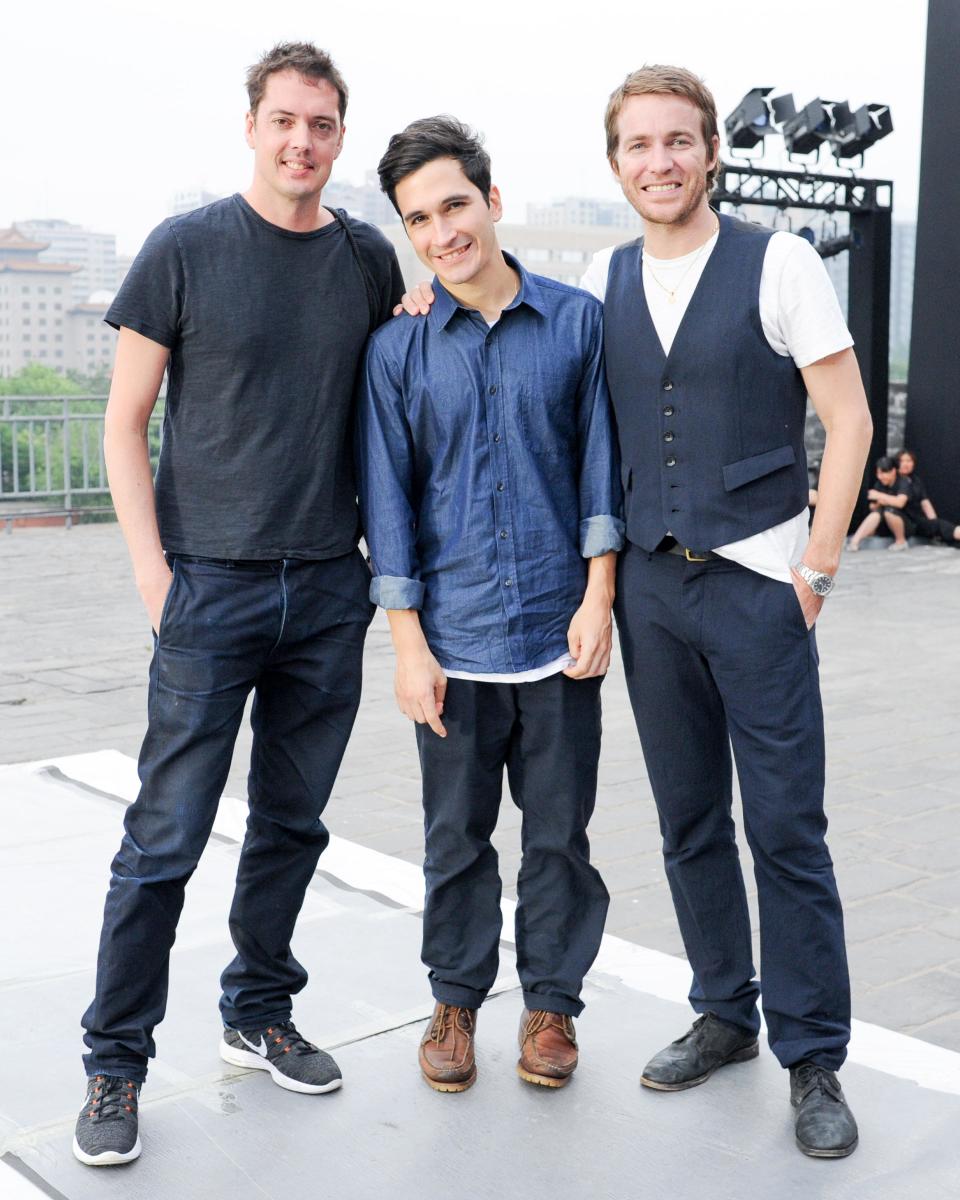 This June 2013 photo released by the Council of Fashion Designers of America (CFDA) shows, Rag & Bone designers Marcus Wainwright, left, and David Neville, right, with Proenza Schouler designer Lazaro Hernandez during preparations for a fashion show by New York-based designers in Beijing, China. Rag & Bone, Marchesa and Proenza Schouler, among the top in their class of cool, youngish New York-based fashion houses, took a field trip to China recently to introduce themselves to Chinese consumers and to bring home a better understanding of their needs. (AP Photo/Council of Fashion Designers of America, Neil Rasmus)