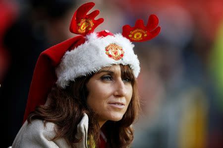 Football Soccer - Manchester United v Norwich City - Barclays Premier League - Old Trafford - 19/12/15 Manchester United fan wearing a Christmas hat before the game Action Images via Reuters / Carl Recine Livepic EDITORIAL USE ONLY. No use with unauthorized audio, video, data, fixture lists, club/league logos or "live" services. Online in-match use limited to 45 images, no video emulation. No use in betting, games or single club/league/player publications. Please contact your account representative for further details. - RTX1ZDBH