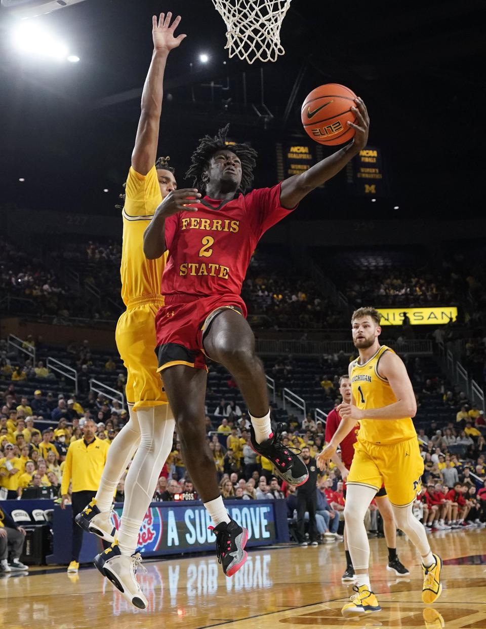 Ferris State guard Amari Le (2) makes a layup as Michigan guard Jett Howard defends during the first half of an exhibition game at Crisler Center in Ann Arbor on Friday, Nov. 4, 2022.