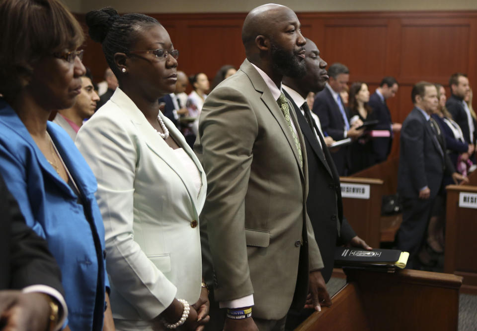 FILE - Trayvon Martin's parents, Sybrina Fulton, second from left, and Tracy Martin, stand in court as the jury leaves the courtroom to deliberate during George Zimmerman's trial in Seminole County, Fla., circuit court, July 12, 2013, in Sanford, Fla. Zimmerman was charged with second-degree murder for the 2012 shooting death of Trayvon, but was later aquitted. The Black Lives Matter movement hits a milestone on Thursday, July 13, 2023, marking 10 years since its 2013 founding in response to Zimmerman's acquittal. (Gary W. Green/Orlando Sentinel via AP, Pool, File)