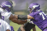 Minnesota Vikings tackle Brian O'Neill (75) blocks defensive end Danielle Hunter (99) during NFL football training camp Friday, July 30, 2021, in Eagan, Minn. (AP Photo/Bruce Kluckhohn)