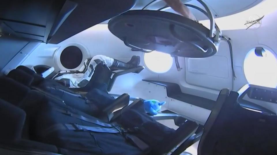 Inside of Crew Dragon capsule viewed through hatch of ISS