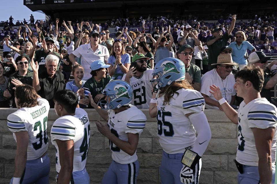 Tulane players celebrate with fans after an NCAA college football game against Kansas State Saturday, Sept. 17, 2022, in Manhattan, Kan. Tulane won 17-10. (AP Photo/Charlie Riedel)