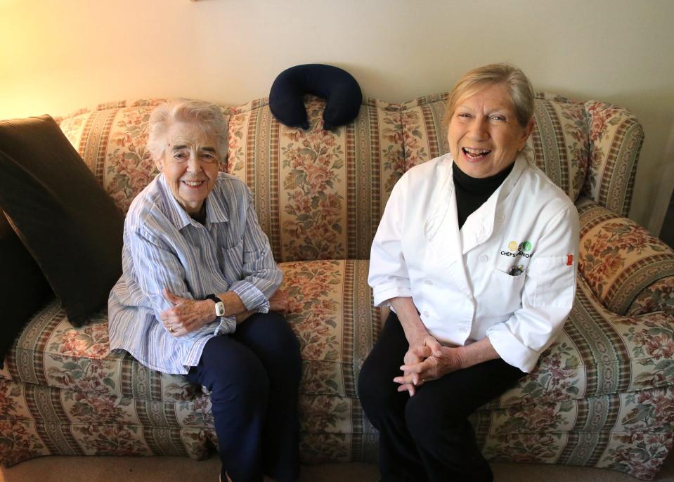 Kittery, Maine, resident Dorothy Richmond, left, and Jean Kerr of Chefs for Seniors meet on Richmond's couch to plan meals.