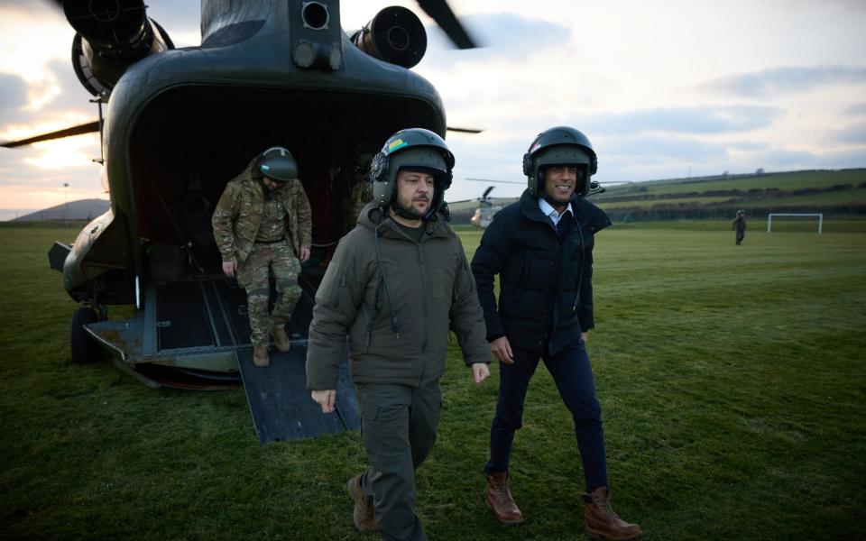 Rishi Sunak and Volodymyr Zelensky are pictured arriving to visit Ukrainian troops being trained to command Challenger 2 tanks at a military facility in Lulworth, Dorset, yesterday - PA