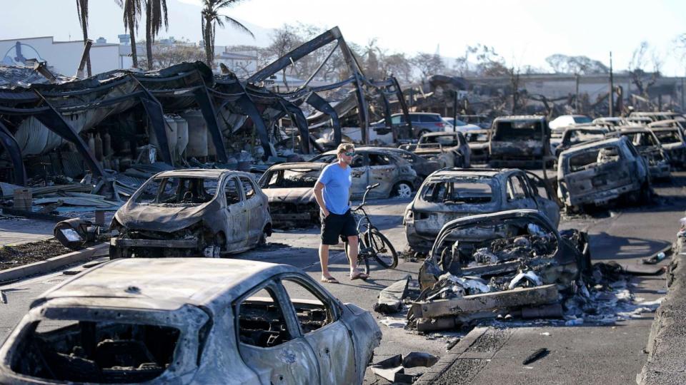 PHOTO: A man walks through wildfire wreckage Aug. 11, 2023, in Lahaina, Hawaii. (Rick Bowmer/AP, FILE)