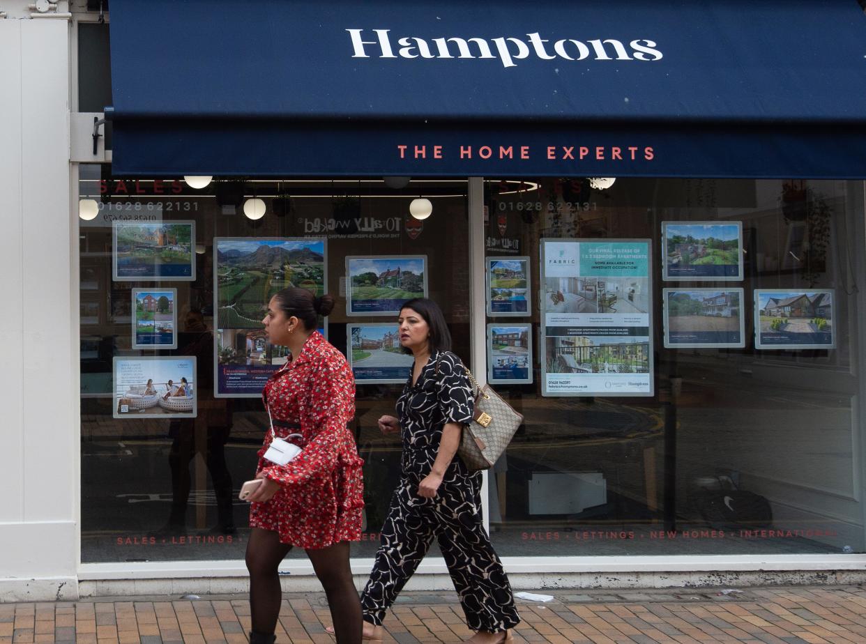 UK house prices: People walk past an Estate Agents in Maidenhead town centre, Berkshire