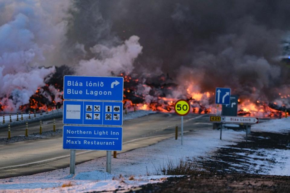 Molten lava is seen overflowing the road leading to the Blue Lagoon.<span class="copyright">Kristinn Magnusson—AFP/Getty Images</span>