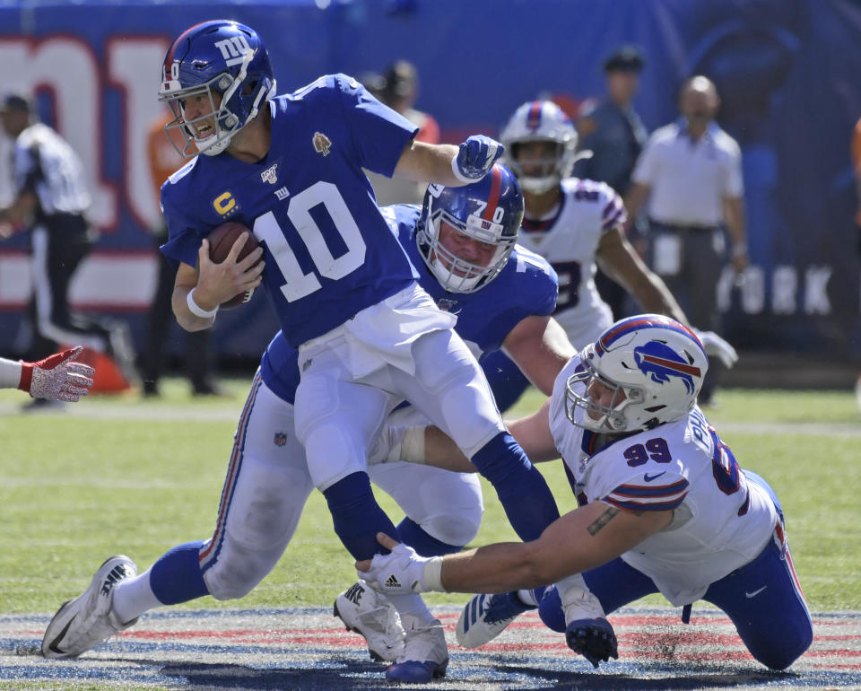 New York Giants quarterback Eli Manning (10) fumbles the ball as he is tackled behind the line of scrimmage during the second half of an NFL football game against the Buffalo Bills, Sunday, Sept. 15, 2019, in East Rutherford, N.J. (AP Photo/Bill Kostroun)