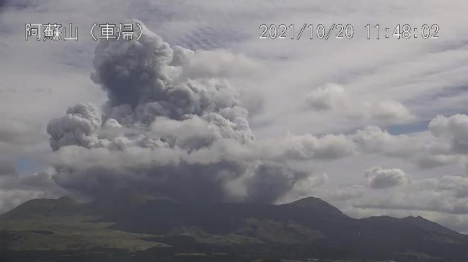 In this image taken by a surveillance camera released by Japan Meteorological Agency, smokes rise from the No. 1 Nakadake crater of Mr. Aso after its eruption, observed from Kurumagaeri, southwestern Japan, Wednesday, Oct. 20, 2021. The eruption occurred at 11:43 a.m., according to the agency. (Japan Meteorological Agency via AP)