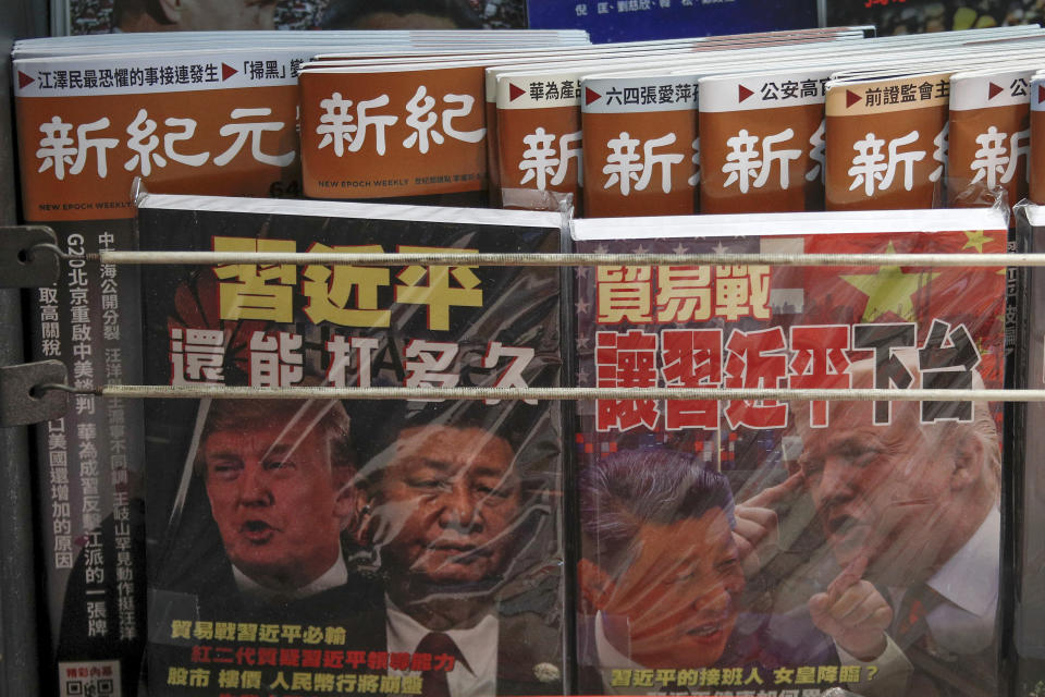 FILE - In this July 4, 2019, photo, Chinese magazines with front covers featuring Chinese President Xi Jinping and U.S. President Donald Trump on trade war are placed for sale at a roadside bookstand in Hong Kong. China on Thursday, Aug. 15, 2019 threatened retaliation if Washington steps up their war over trade and technology by going ahead with planned Sept. 1 tariff hikes on additional Chinese imports. (AP Photo/Andy Wong, File)