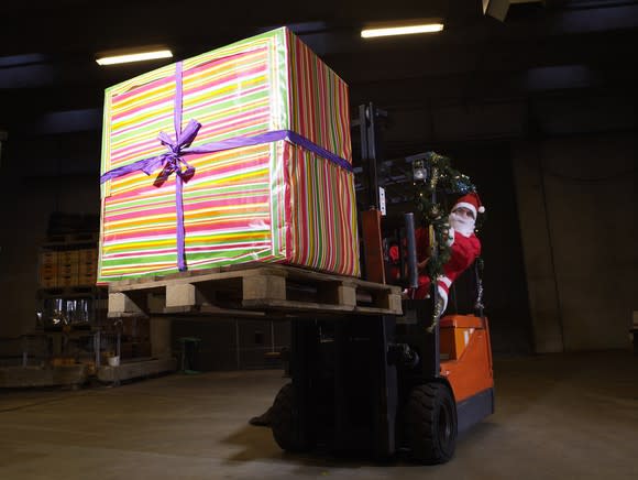 Santa delivering a big present via forklift