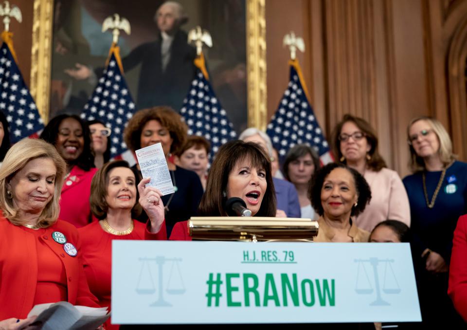 Rep. Jackie Speier, D-Calif., holds up a copy of the Constitution during an event about their resolution to remove the deadline for ratification of the Equal Rights Amendment.
