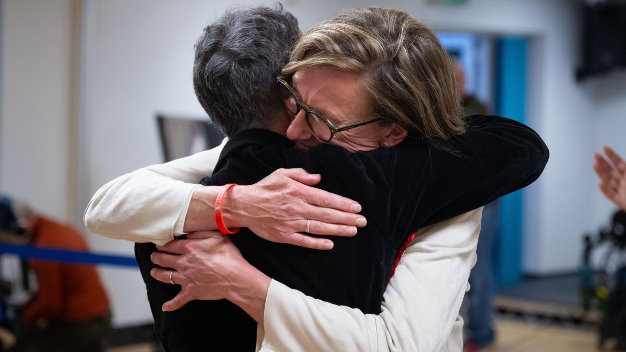 Labour candidate Catherine Fookes hugs a supporter after winning the Monmouth constituency