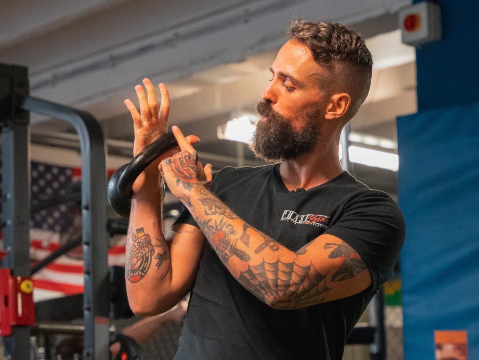 Jay Rose demonstrating the angle to hold a kettlebell.