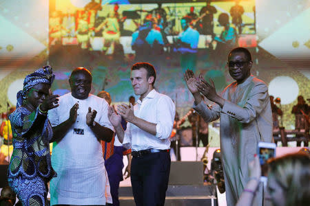 French President Emmanuel Macron stands on stage with Angelie Kidjo (L), Lagos state governor Akinwunmi Ambode (2nd L) and Senegalese singer Youssou N'Dour during Macron's visit to the Afrika Shrine nightclub in Nigeria's commercial capital Lagos, July 3, 2018. REUTERS/Akintunde Akinleye