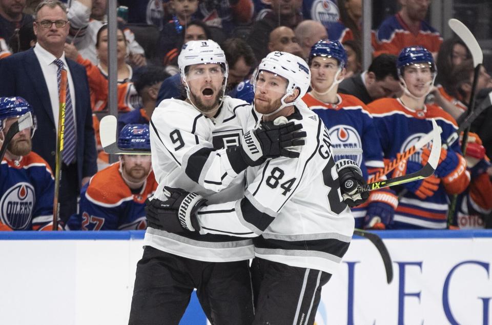 Kings forward Adrian Kempe, left, celebrates with defenseman Vladislav Gavrikov.