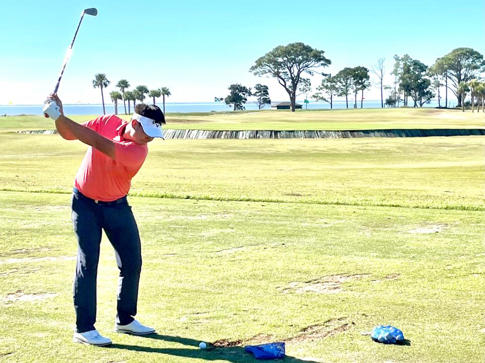 Carl Yuan loosens up on the Sea Island practice range on Tuesday after shooting 62 at the Brunswick Country Club on Monday to qualify for the RSM Classic.