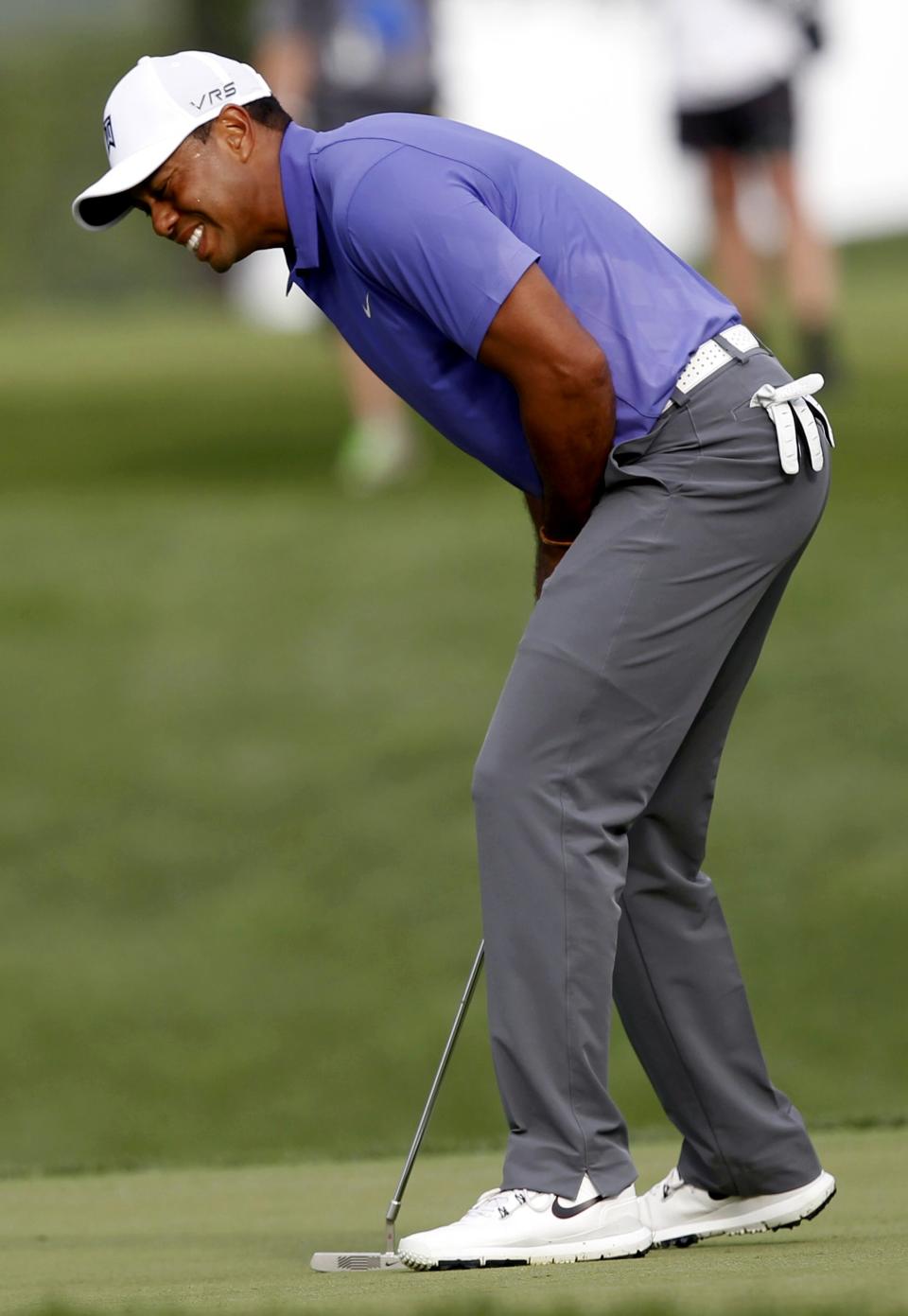 Tiger Woods of the U.S. reacts after a missed putt on the 10th green during the first round of the PGA Championship at Valhalla Golf Club in Louisville, Kentucky, August 7, 2014. REUTERS/John Sommers II