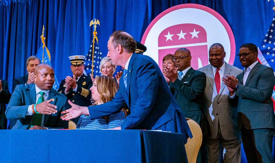 Milwaukee Mayor Cavalier Johnson, from left, Chairperson of the Republican National Committee Ronna McDaniel and former RNC chair Reince Priebus sign the official document selecting Milwaukee to host the 2024 Republican National Convention on Friday at the JW Marriott in Chicago. Behind them are Paul Farrow, from left, chairman of the Wisconsin Republican Party; Milwaukee Fire Chief Aaron Lipsky; Peggy Williams-Smith, president and chief executive of VISIT Milwaukee; Milwaukee Police Chief Jeffrey Norman; Anne Hathaway, leader of the RNC site selection committee; Milwaukee County Sheriff Earnell Lucas; Gerard Randall, first vice chairman of the state GOP; and Milwaukee County Executive David Crowley.