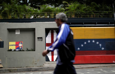 A man walks in front of the house of Venezuelan opposition leader Leopoldo Lopez in Caracas, Venezuela August 1, 2017. REUTERS/Ueslei Marcelino