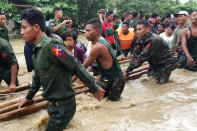 <p>People are evacuated by Myanmar soldiers after flooding in Swar township, Myanmar, Aug. 29, 2018. (Photo: Stringer/Reuters) </p>