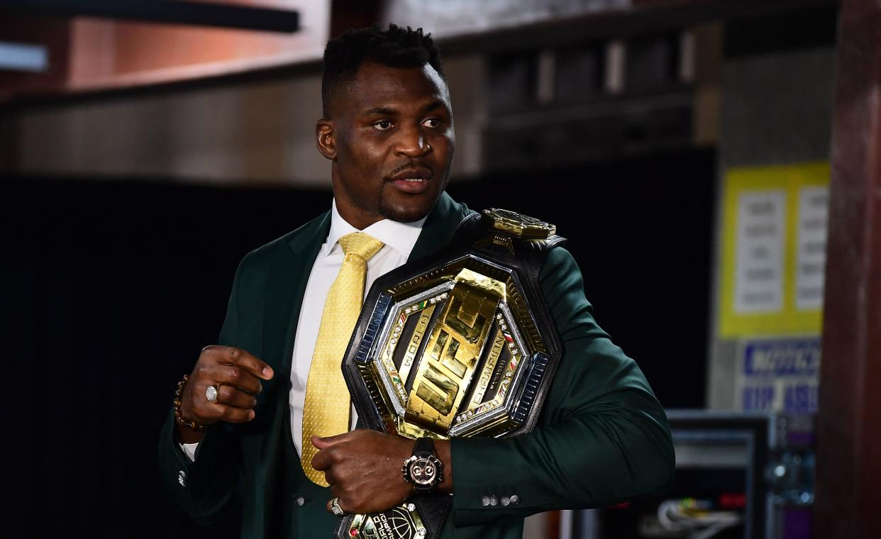 Champion Cameroon's Francis Ngannou holds the championship belt in the press room after defeating French Cyril Gane in their UFC 270 championship fight in Anaheim on January 22, 2022. (Photo by Frederic J. BROWN / AFP) (Photo by FREDERIC J. BROWN/AFP via Getty Images)
