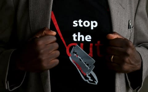 a man wears a t-shirt advocating against the practice - Credit: Reuters