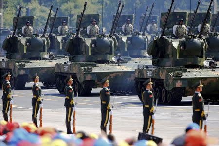 China's People's Liberation Army (PLA) soldiers on their armoured vehicles equipped with anti-aircraft artillery roll to Tiananmen Square during the military parade marking the 70th anniversary of the end of World War Two, in Beijing, China, September 3, 2015. REUTERS/Damir Sagolj