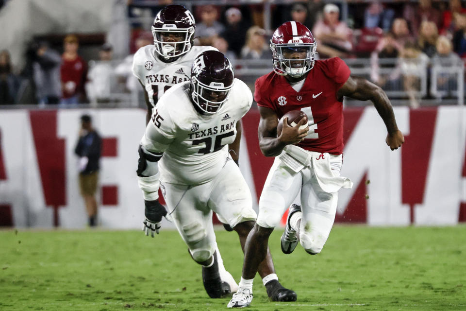 Oct 8, 2022; Tuscaloosa, Alabama; Alabama Crimson Tide quarterback Jalen Milroe (4) scrambles away from Texas A&M Aggies defensive lineman McKinnley Jackson (35) during the first half at Bryant-Denny Stadium. Butch Dill-USA TODAY Sports