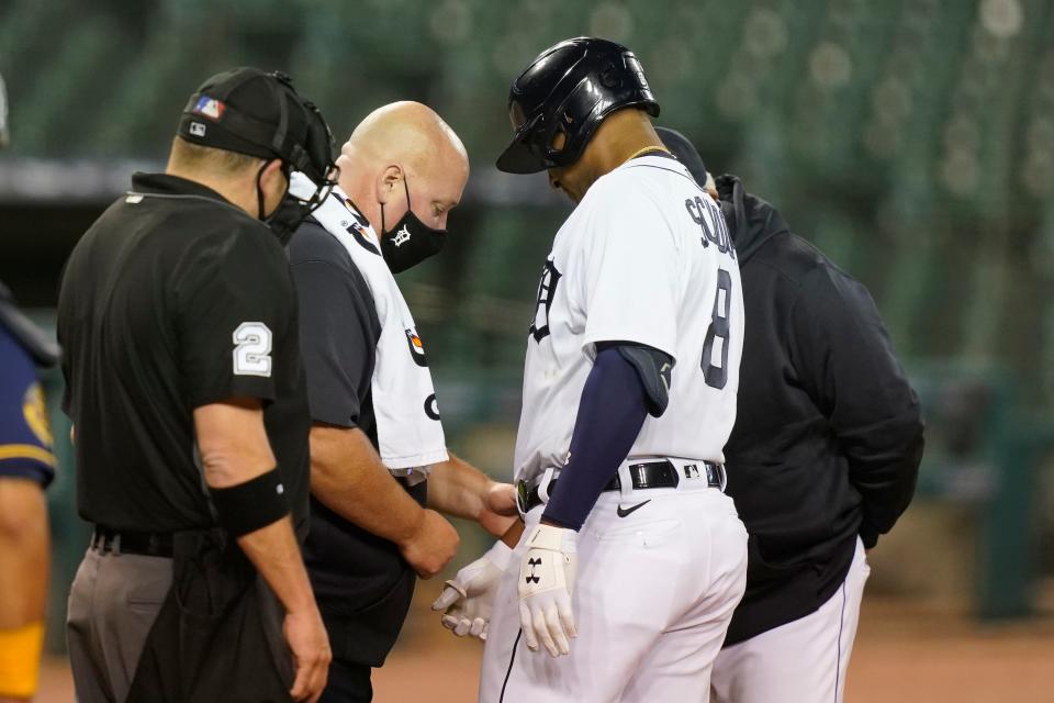 Tigers second baseman Jonathan Schoop has his hand checked after being hit by a pitch during the fourth inning against the Brewers on Tuesday, Sept. 8, 2020, at Comerica Park.