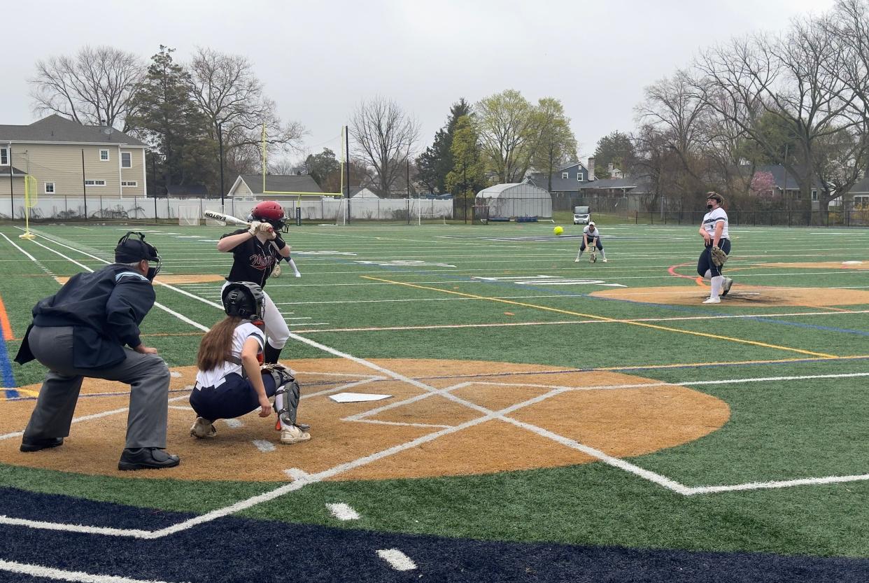 Manasquan's Lindsay Fuller (right in white) throws a pitch to a Matawan batter.