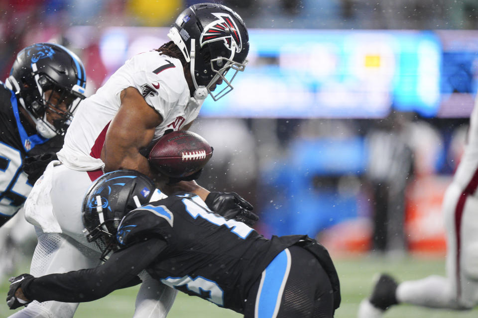 Carolina Panthers cornerback Troy Hill forces a fumble by Atlanta Falcons running back Bijan Robinson during the second half of an NFL football game Sunday, Dec. 17, 2023, in Charlotte, N.C. (AP Photo/Jacob Kupferman)