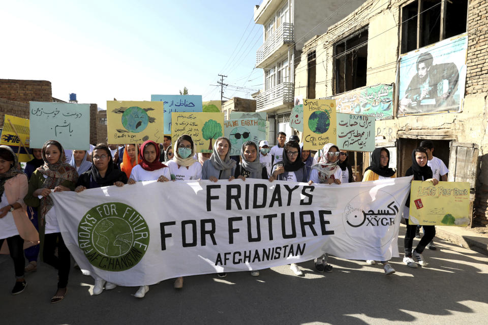 Young people attend a Climate Strike rally, in Kabul, Afghanistan, Friday, Sept. 20, 2019. In the Afghan capital, where people are dying every day in horrific bomb attacks, a young generation, worried that if war doesn't kill them climate change will, took part in the global climate strike. (AP Photo/Ebrahim Noroozi)