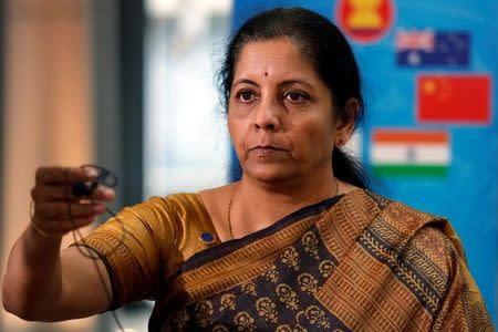 FILE PHOTO: Nirmala Sitharaman returns a microphone after speaking with media at the 3rd Intersessional Regional Comprehensive Economic Partnership (RCEP) Ministerial Meeting in Hanoi, Vietnam May 22, 2017. REUTERS/Kham/Files